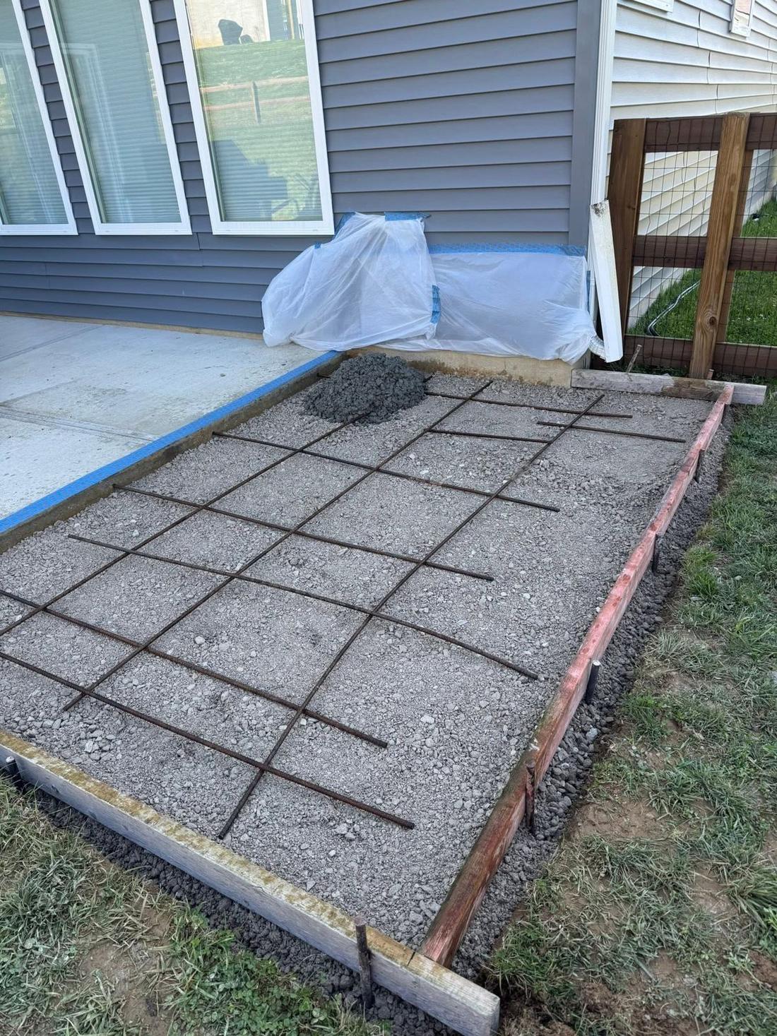 Formed and reinforced concrete pad