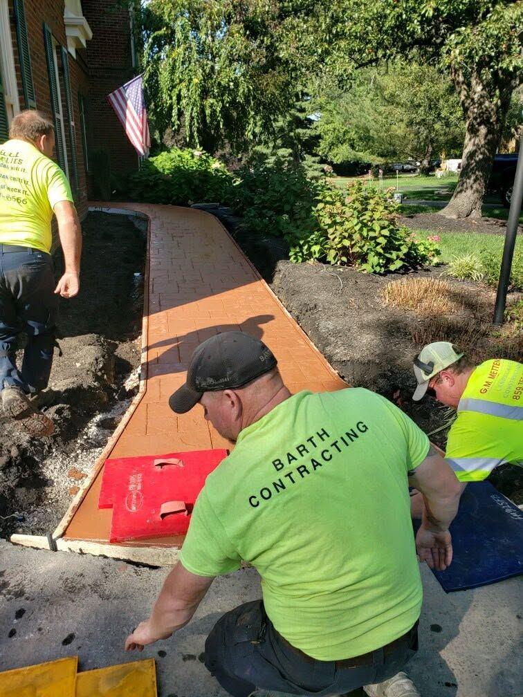 Crew setting pavers on site