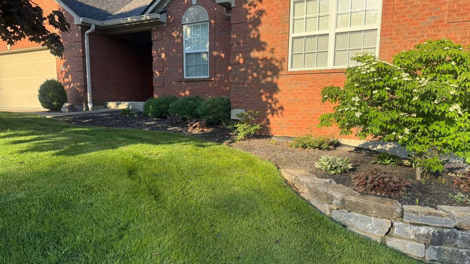 Stone retaining wall and plantings built by Barth Contracting